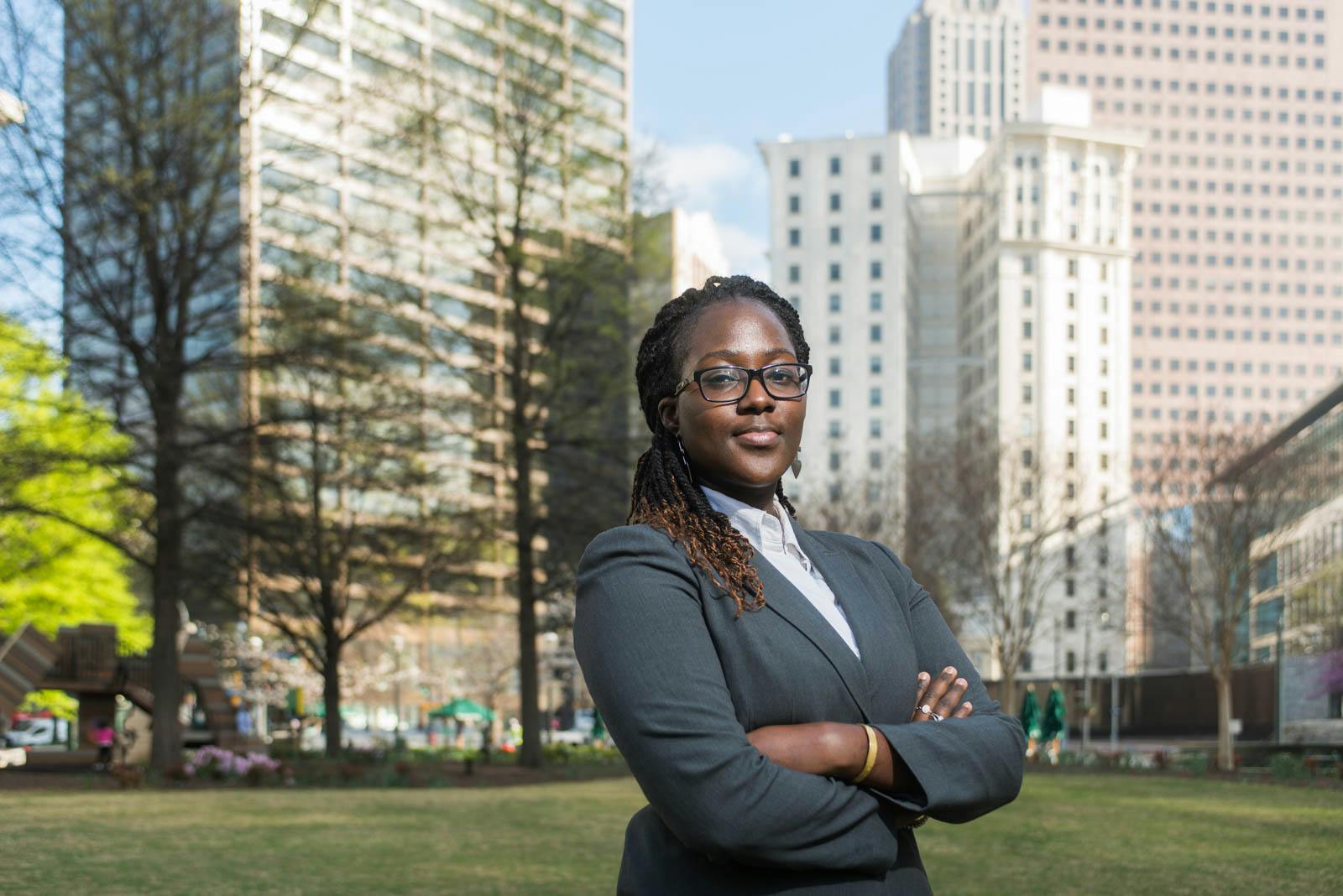 A young woman in business attire posing confidently in downtown Atlanta, GA.